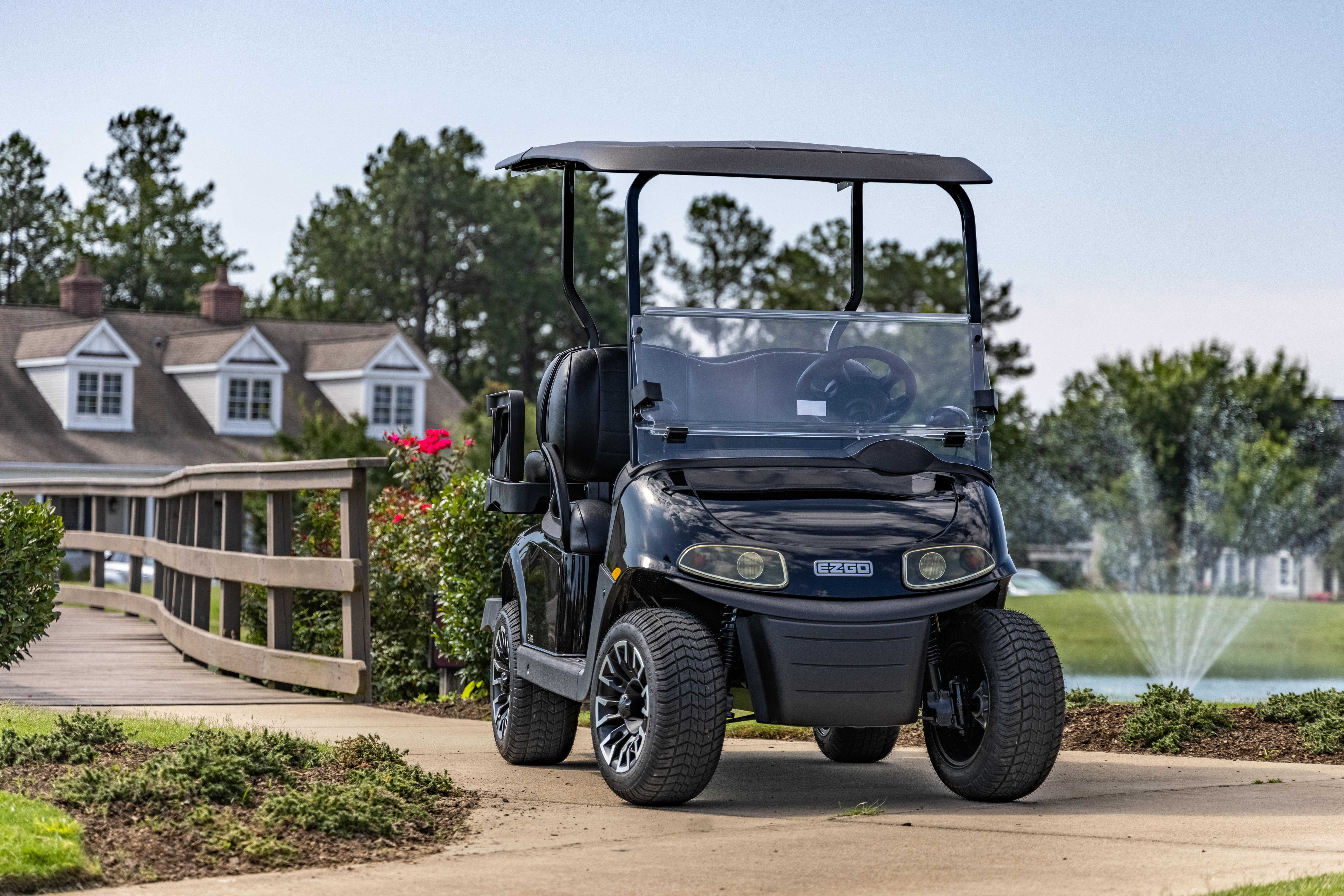 Friends riding E-Z-GO golf cart