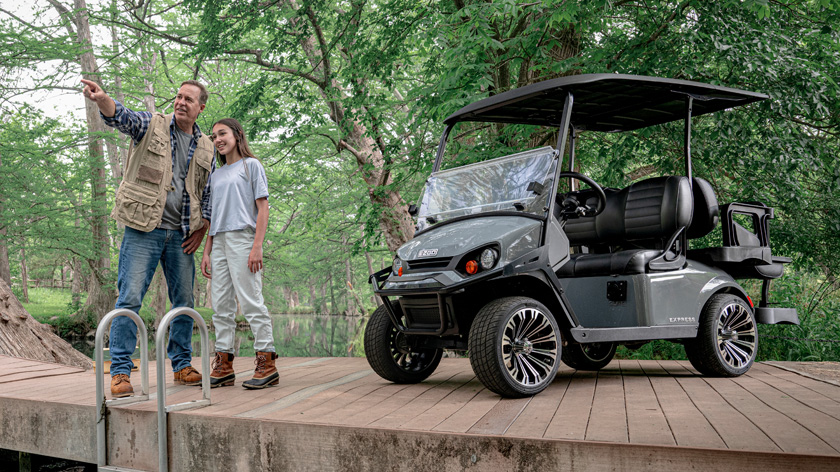 Father and daughter fishing with E-Z-GO golf cart