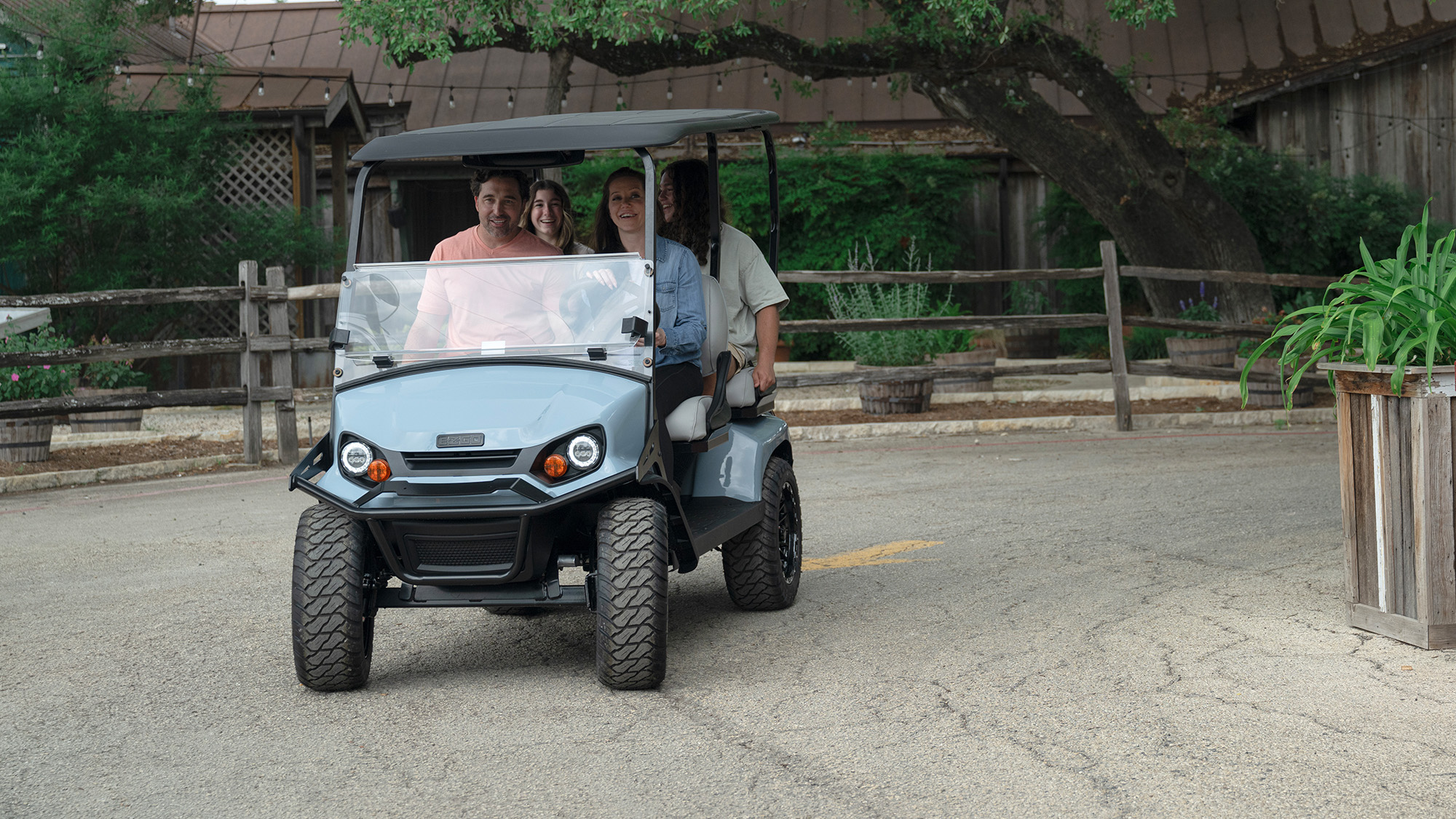Group of 4 driving the Liberty in a neighborhood