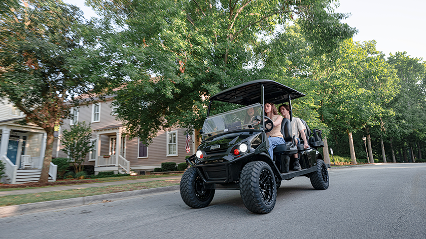 Express 6 driving in a neighborhood with a family of 5