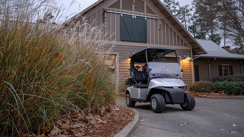 RXV ELiTE golf cart sitting in front of a club house cart barn
