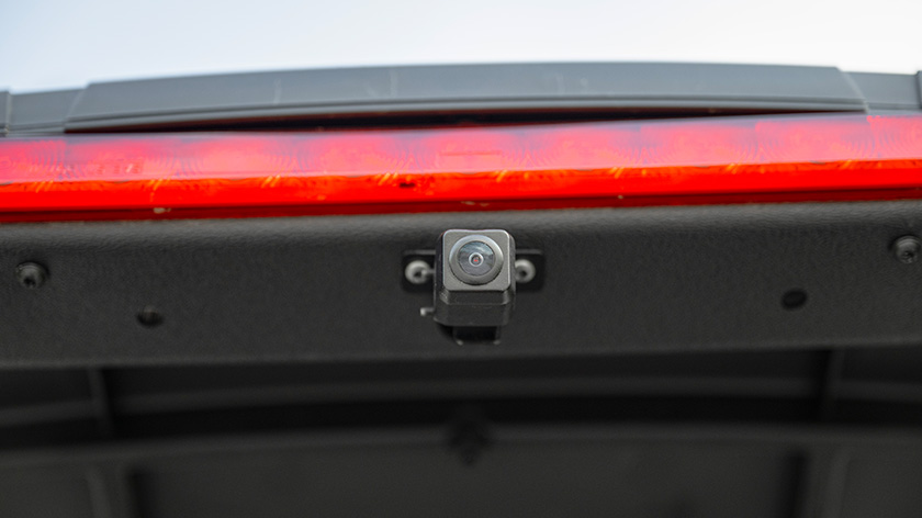Screen-intergrated backup camera mounted below brake light