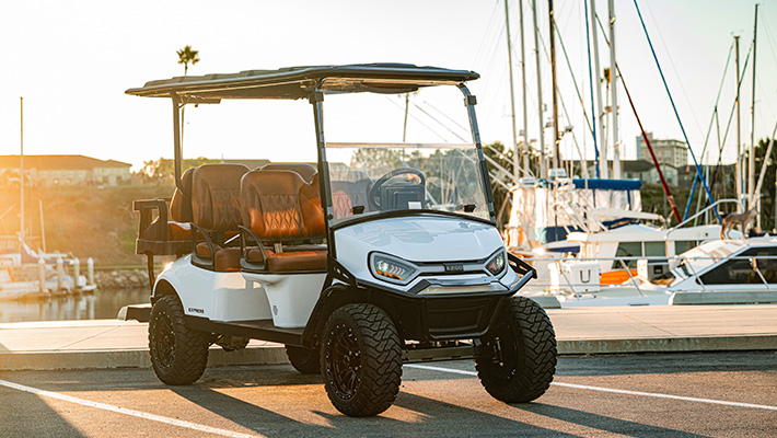Express 6 parked in a parking spot with a marina/harbor in the background