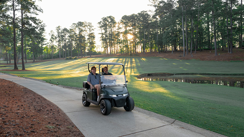 RXV 2 with father and son riding on cart path of a golf course