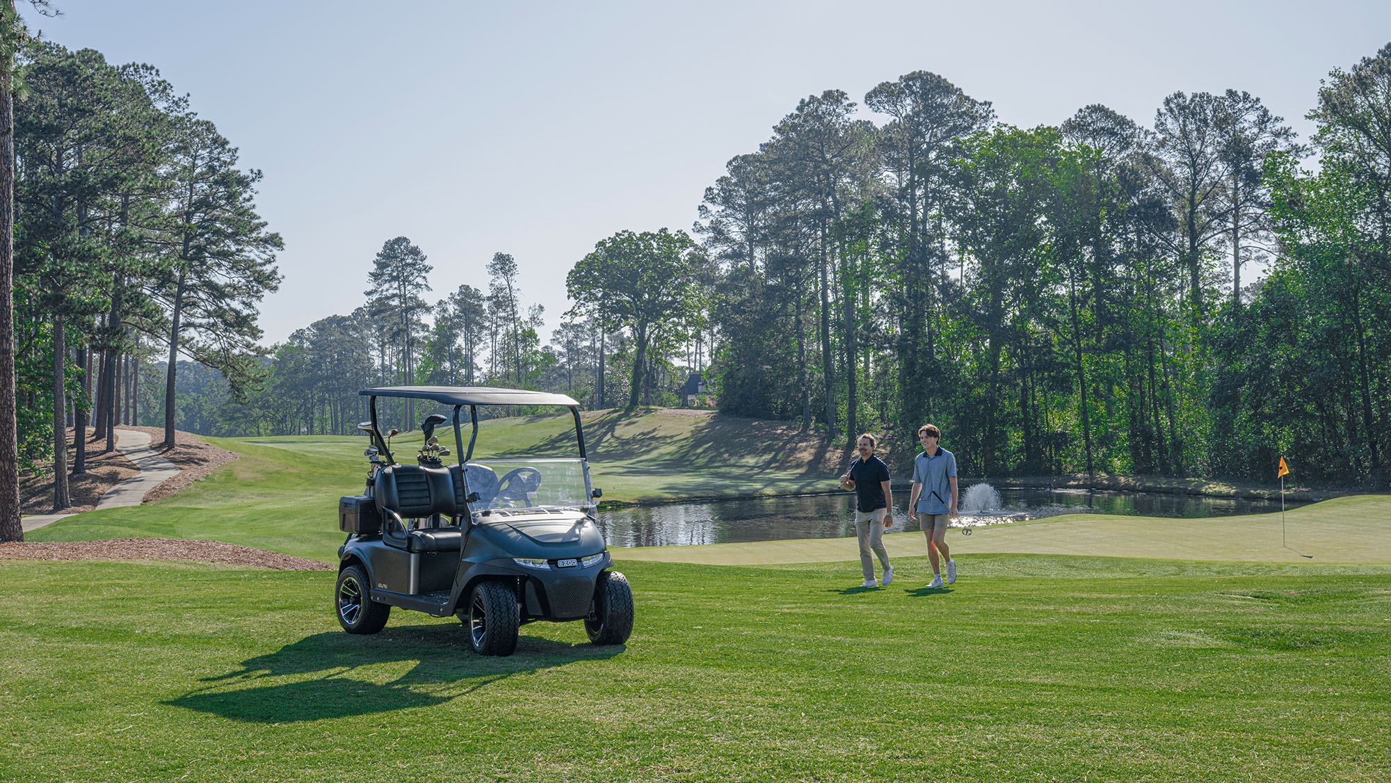 RXV 2 on a golf course with a father and son walking towards the cart