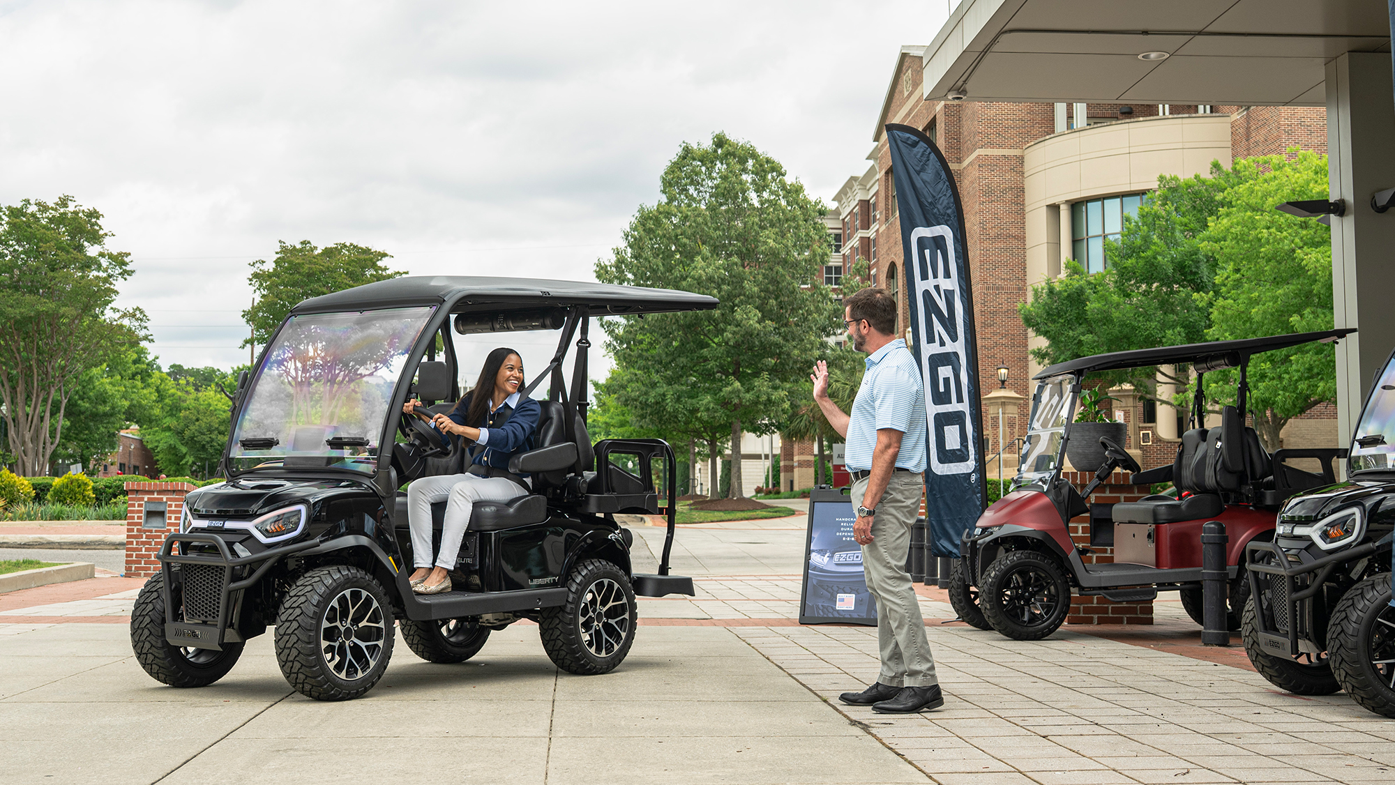 E-Z-GO Liberty 4 with 2 forward, 2 backward seats electric or gas golf cart leaving a golf cart dealership
